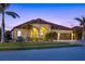 Attractive one-story home with a tile roof, arched entryway, and landscaped yard at 20450 Passagio Dr, Venice, FL 34293