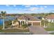 Single-story home with tile roof, two-car garage, and landscaping at 20450 Passagio Dr, Venice, FL 34293