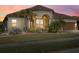 Stunning home with three-car garage at dusk at 20450 Passagio Dr, Venice, FL 34293