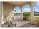 Spacious front porch with arched entryway, overlooking a peaceful neighborhood at 20450 Passagio Dr, Venice, FL 34293