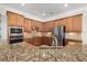 Modern kitchen featuring granite countertops and ample cabinetry at 20450 Passagio Dr, Venice, FL 34293