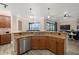 Large kitchen island with granite countertops and a double sink at 20450 Passagio Dr, Venice, FL 34293