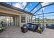 Spacious covered patio with comfortable seating and a hot tub at 20450 Passagio Dr, Venice, FL 34293