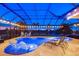 Luxury pool with a unique shape and nighttime lighting at 20450 Passagio Dr, Venice, FL 34293