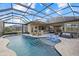 Luxury pool and patio area with covered lanai and seating at 20450 Passagio Dr, Venice, FL 34293