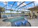 Resort-style pool with covered patio and lounge chairs at 20450 Passagio Dr, Venice, FL 34293