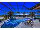 Relaxing pool area with lounge chairs and a view of the lake at 20450 Passagio Dr, Venice, FL 34293
