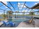 Inviting freeform pool with covered patio and lounge chairs at 20450 Passagio Dr, Venice, FL 34293