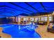 Stunning pool and lanai area with covered seating, outdoor kitchen, and spa at 20450 Passagio Dr, Venice, FL 34293
