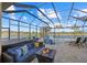 Covered lanai with pool, spa, and fire pit at 20450 Passagio Dr, Venice, FL 34293