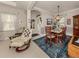 Dining room with wooden table and chairs, adjacent to entryway at 229 Marcheno Way, Nokomis, FL 34275