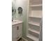 Bathroom with vanity, shelving and mirror at 232 Saint Augustine Ave # 704, Venice, FL 34285