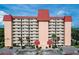 Front view of a multi-story building with red roof and ample parking at 232 Saint Augustine Ave # 704, Venice, FL 34285