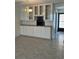 Bright kitchen featuring built-in cabinets and tiled floors at 232 Saint Augustine Ave # 704, Venice, FL 34285