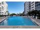 Inviting community pool with surrounding lounge chairs and patio area at 232 Saint Augustine Ave # 704, Venice, FL 34285