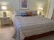 Bright bedroom with striped bedding and two matching nightstands at 244 Saint Augustine Ave # 805, Venice, FL 34285