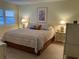 Bright bedroom featuring a king-size bed and stylish decor at 244 Saint Augustine Ave # 805, Venice, FL 34285