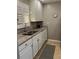 Efficient kitchen with white cabinets, granite counters, and modern appliances at 244 Saint Augustine Ave # 805, Venice, FL 34285