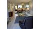 Open living area with a sofa, recliner, and a glass-top coffee table at 244 Saint Augustine Ave # 805, Venice, FL 34285