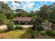 Single-story home with brown roof, driveway, and lush landscaping at 2542 Northway Dr, Venice, FL 34292