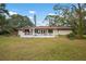 Large backyard with deck and spacious grassy area at 2542 Northway Dr, Venice, FL 34292