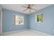 Bedroom with light blue walls, ceiling fan, and tiled floor at 2542 Northway Dr, Venice, FL 34292