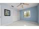 Bedroom with light blue walls, ceiling fan, and tiled floor at 2542 Northway Dr, Venice, FL 34292