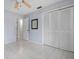 Bedroom with light blue walls, ceiling fan, and tiled floor at 2542 Northway Dr, Venice, FL 34292