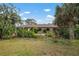 House with brown roof, arched entryway, and green lawn at 2542 Northway Dr, Venice, FL 34292