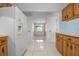 Bright kitchen features wood cabinets, tile floors, and white appliances at 2542 Northway Dr, Venice, FL 34292