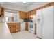 Kitchen offers wood cabinets, tile floors and white appliances at 2542 Northway Dr, Venice, FL 34292