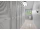 Laundry room with built-in storage and mini-fridge at 2542 Northway Dr, Venice, FL 34292
