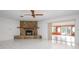 Living room with stone fireplace and view into Florida room at 2542 Northway Dr, Venice, FL 34292