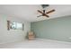 Living room with tile floors, ceiling fan, and large wall at 2542 Northway Dr, Venice, FL 34292