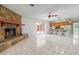 Spacious living room with stone fireplace and kitchen view at 2542 Northway Dr, Venice, FL 34292