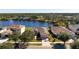 Birds-eye view of a house near a lake in a residential community at 2558 Hobblebrush Dr, North Port, FL 34289