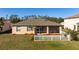 Home's backyard with screened patio and white fence at 2558 Hobblebrush Dr, North Port, FL 34289