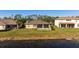 Home's backyard with screened patio and lake view at 2558 Hobblebrush Dr, North Port, FL 34289