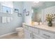 Light blue bathroom with white vanity, toilet, and shower at 2558 Hobblebrush Dr, North Port, FL 34289