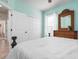 Bedroom with white bedding, dresser and large closet at 2558 Hobblebrush Dr, North Port, FL 34289