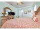 Main bedroom with TV and peach bedding at 2558 Hobblebrush Dr, North Port, FL 34289