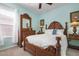 Bedroom with wooden bed frame and light blue walls at 2558 Hobblebrush Dr, North Port, FL 34289