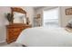 Bedroom with wooden dresser and a large window at 2558 Hobblebrush Dr, North Port, FL 34289