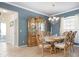 Elegant dining room featuring a china cabinet and chandelier at 2558 Hobblebrush Dr, North Port, FL 34289