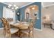 Formal dining room with a large wooden table and chandelier at 2558 Hobblebrush Dr, North Port, FL 34289