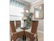 Charming dining room with wicker chairs and a glass table at 2558 Hobblebrush Dr, North Port, FL 34289