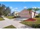 House exterior, two-car garage, and a fountain at 2558 Hobblebrush Dr, North Port, FL 34289