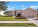 Single-story house with a two-car garage and landscaped lawn at 2558 Hobblebrush Dr, North Port, FL 34289