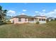 House back view, fenced backyard, and palm trees at 2558 Hobblebrush Dr, North Port, FL 34289