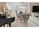 Kitchen boasts white cabinets, granite counters, and a breakfast bar at 2558 Hobblebrush Dr, North Port, FL 34289